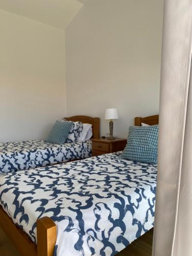 two beds sitting next to each other in a bedroom at Mine House in Calheta