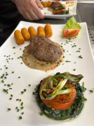 a plate of food with meat and vegetables on it at Landhaus Donautal in Fridingen an der Donau