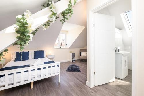 a bedroom with a bed with flowers on the ceiling at Spacious City Centre 2 Bedroom Penthouse with Cathedral Views in Canterbury