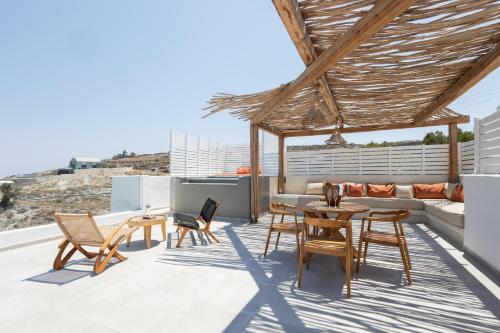 a patio with chairs and a table on a roof at Divino Caldera in Akrotiri