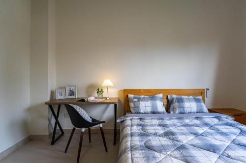 a bedroom with a bed and a desk with a chair at Thao Dien Coliving in Ho Chi Minh City
