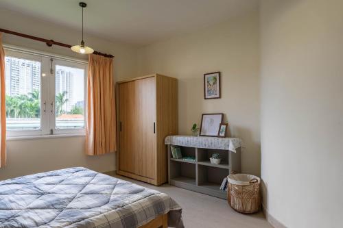 a bedroom with a bed and a sink and a window at Thao Dien Coliving in Ho Chi Minh City