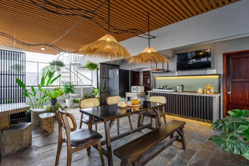 a kitchen and living room with a table and chairs at Thao Dien Coliving in Ho Chi Minh City