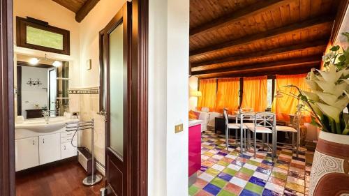 a bathroom with a sink and a table in a room at La Finestra sulle Eolie in Reitano