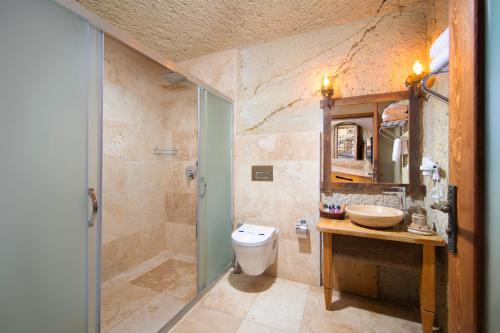 a bathroom with a toilet and a sink at Portal Cappadocia Hotel in Ortahisar
