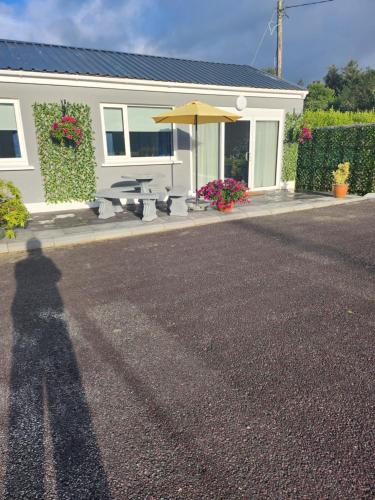 a shadow of a person standing in front of a house at Kiln lodge in Killarney