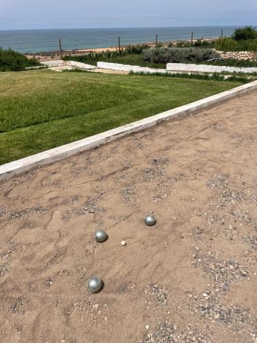 two balls on the ground on a dirt road at Villa La Falaise in Oualidia