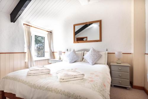 Voodi või voodid majutusasutuse Ta Mill Cottages & Lodges - Smithy Cottage toas