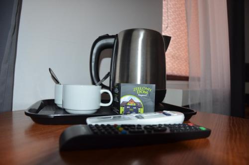 a coffee maker and a remote control on a table at Zielony Dom in Bolesławiec
