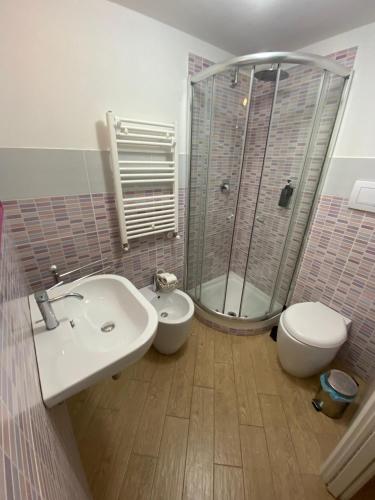 a bathroom with a sink and a toilet and a shower at Manu's House B&B in Porto Empedocle
