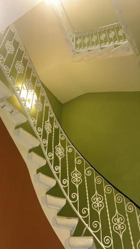 a spiral staircase in a room with a green ceiling at King Charles Hotel in Valletta
