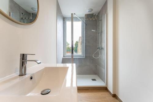 une salle de bain blanche avec un lavabo et une douche dans l'établissement Rooftop - Villa Leone - Appartement à 500m plage, à La Tente-Verte