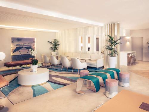 a lobby with a waiting room with chairs and tables at Mercure Villeneuve Loubet Plage in Villeneuve-Loubet
