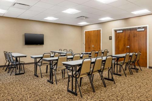 a conference room with tables and chairs and a tv at Comfort Inn & Suites At CrossPlex Village in Birmingham