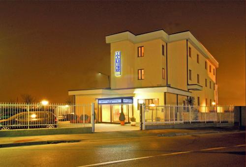 a building with a sign on it at night at Hotel Majestic in San Giuliano Milanese