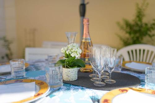 a table with glasses and a bottle of wine at Cosy House with Paris Metro Direct Champs Elysées Eiffel Montmartre in Saint-Denis