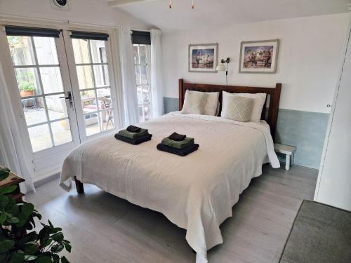 a bedroom with a large bed with two towels on it at Bed & Bentwoud in Benthuizen