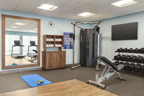 a fitness room with a gym with a television and weights at Hampton Inn & Suites Oroville in Oroville