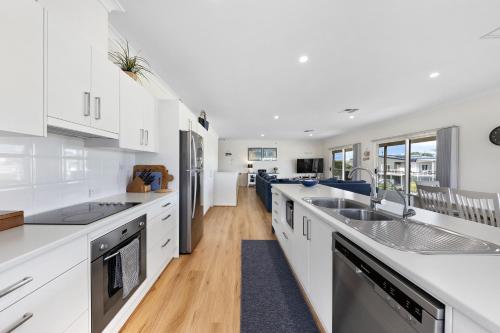 a kitchen with white cabinets and a counter top at The Beach House in Middleton