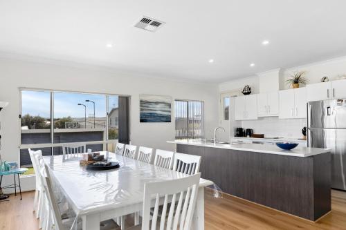 a kitchen and dining room with a table and chairs at The Beach House in Middleton