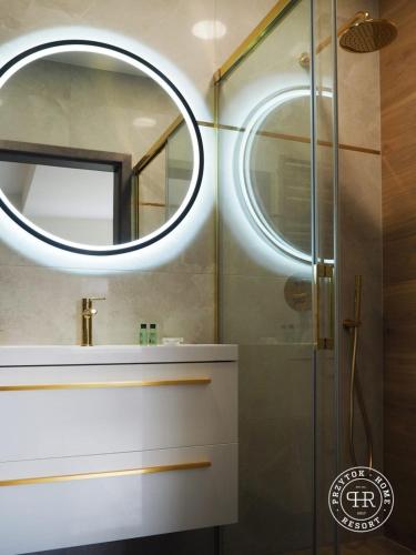 a bathroom with a sink and a mirror at Przytok Golf Resort in Przylok