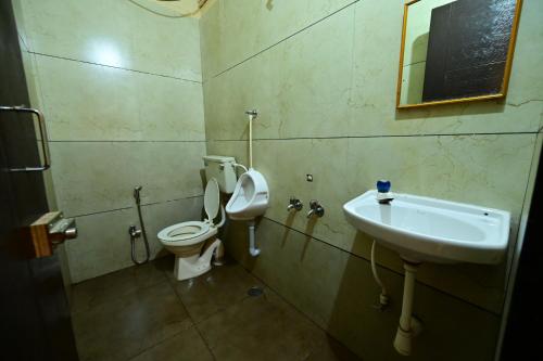 a bathroom with a toilet and a sink at Aasra Lodge in Ratnagiri