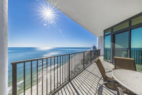 a balcony with a table and chairs and the ocean at The Oasis at Orange Beach 2203 in Orange Beach
