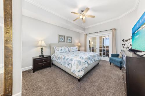 a bedroom with a bed and a tv at The Oasis at Orange Beach 2203 in Orange Beach