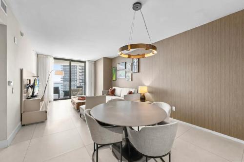 a dining room and living room with a table and chairs at Breathtaking Ocean-View Balcony Lyfe Resort in Beverley Beach