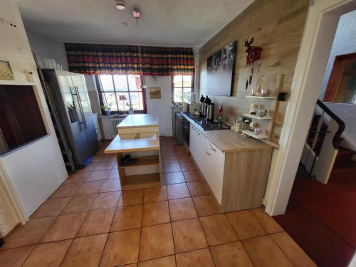 a kitchen with a counter and a table in it at Hotel Schönblick in Bad Herrenalb