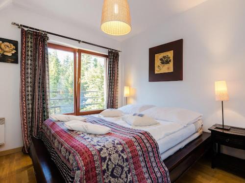 Posteľ alebo postele v izbe v ubytovaní Apartament Egzotyczny Bory