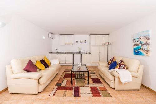a living room with two couches and a table at Apt B Algemesi Moraira in Moraira