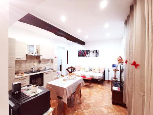 a kitchen with a table and a dining room at La casa del Borgo Anagni in Anagni