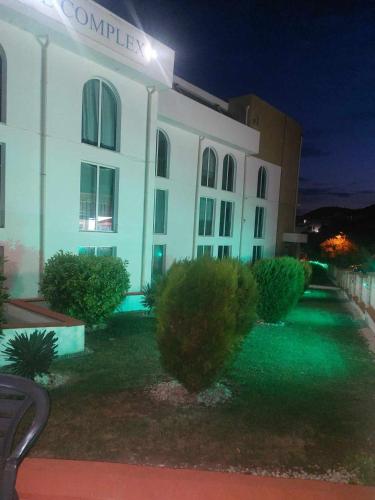 a white building with a sign on it at night at Apartment А13 in Sea Paradise Complex in Kavarna