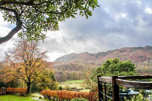 a view of a field with mountains in the background at Lancrigg in Grasmere