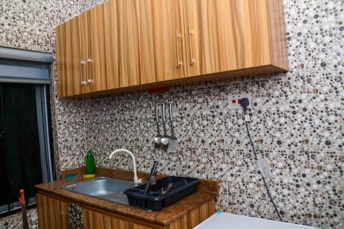 a kitchen with a sink and a counter top at Beautiful and Cosy Furnished 1 Bedroom Apartment in an Exclusive Area - Lekki in Ikota