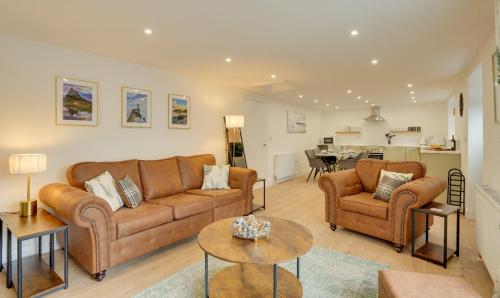a living room with two couches and a table at Harrow Bank Cottage Family and Pet Friendly Coastal Escape in Tweedmouth in Tweedmouth