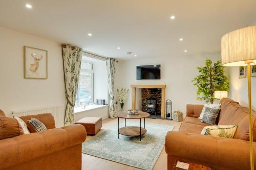 a living room with two couches and a table at Harrow Bank Cottage Family and Pet Friendly Coastal Escape in Tweedmouth in Tweedmouth