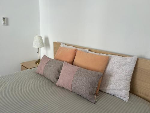 a group of pillows sitting on a bed with at Apartamento Batalha - Quarteira, Algarve, Portugal in Quarteira