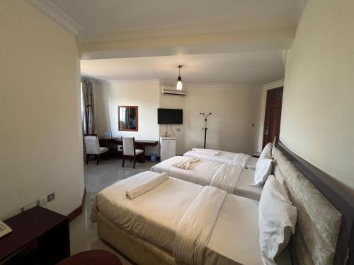 Postel nebo postele na pokoji v ubytování Nejobugg Palace Hotel
