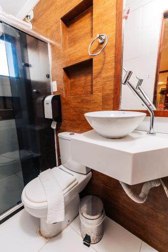 a bathroom with a sink and a toilet and a shower at Pousada Capital das Águas in Maceió