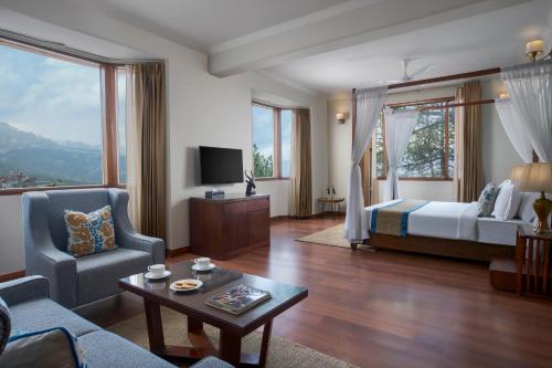 a living room with a bed and a couch at 8fold by LaRiSa in Shimla