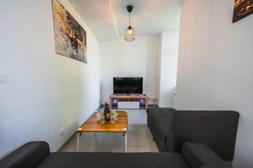 a living room with a couch and a table at Les gîtes Saint-Aignan in Saint-Aignan