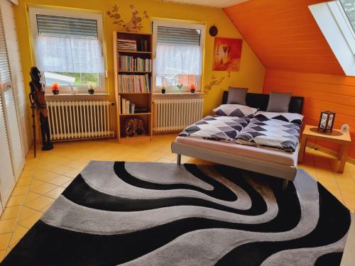 a bedroom with a bed and a rug on the floor at Haus Kalle in Harlesiel