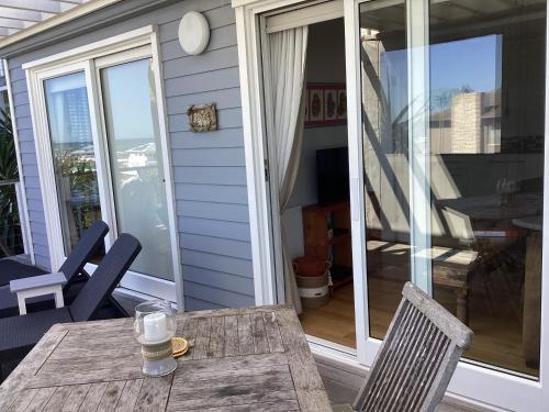 a table and chairs on the porch of a house at Chez James in Yzerfontein