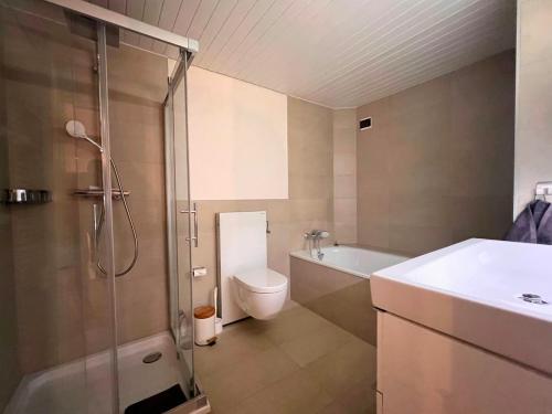 a bathroom with a shower and a toilet and a sink at La Vigneronne, Chailly-Montreux in Montreux