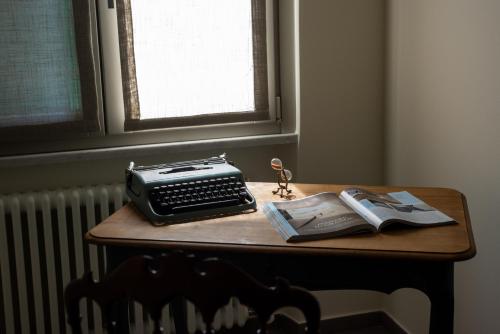 a desk with a typewriter and a book on it at Maison Hublot in Chiavari