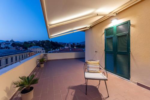 a chair sitting on the balcony of a building at Maison Hublot in Chiavari