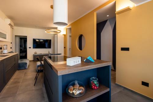 a kitchen and living room with a counter and a sink at Maison Hublot in Chiavari