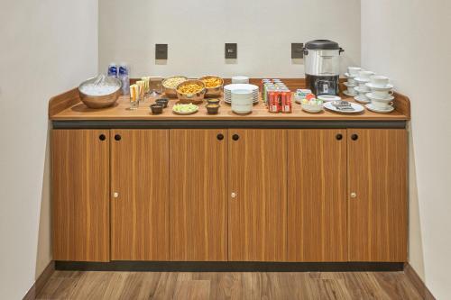 a wooden counter with food on top of it at City Express Plus by Marriott Cancun Aeropuerto Riviera in Cancún